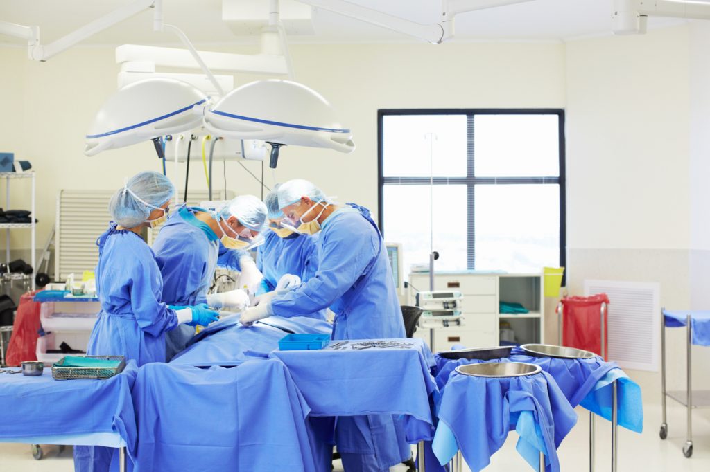 team of surgeons working together surgical staples